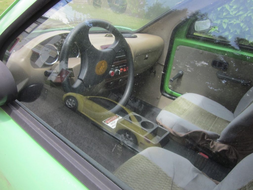 An electric car dashboard shows a large touchscreen display inside the cabin.