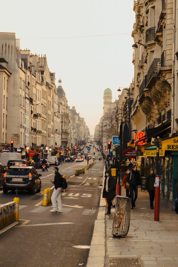 A busy Paris street with historic buildings and pedestrians
