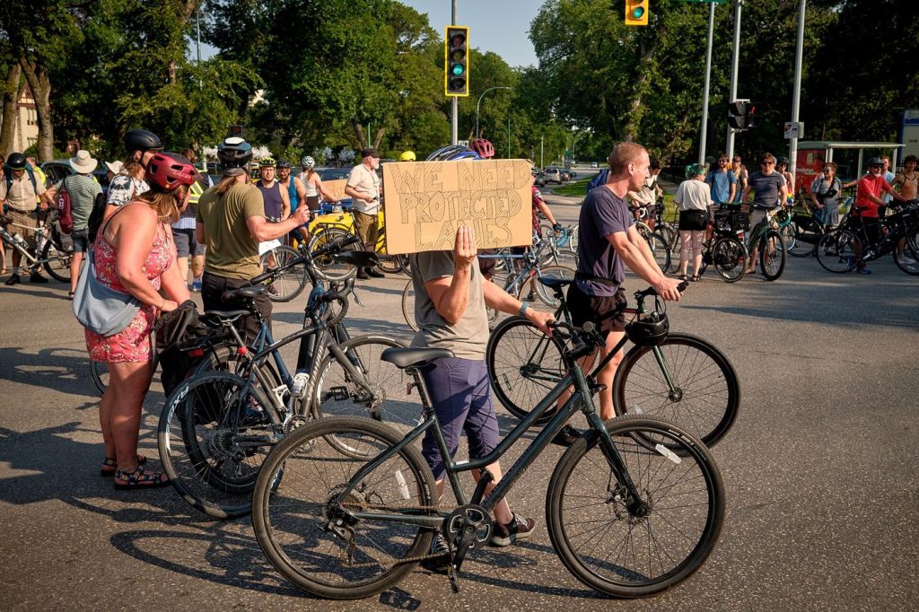 cyclists riding in a protected bike lane