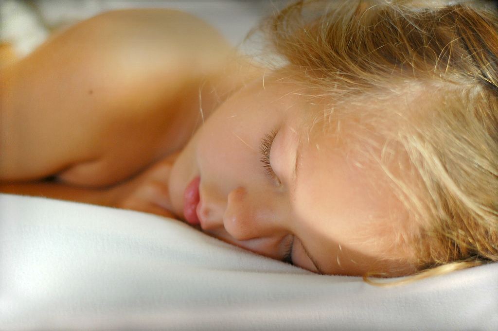 Sleep Pressure Builds Differently in Night Owls person sleeping peacefully in a dark bedroom